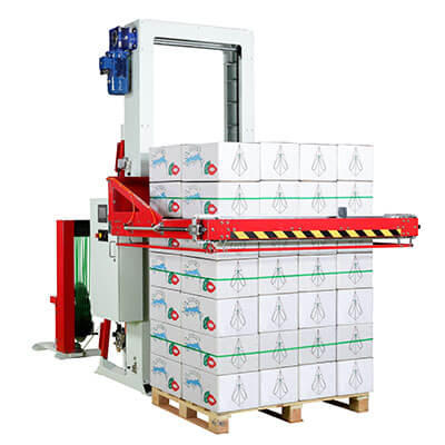 Horizontal baler strapping pallet and skid loads in horizontal direction